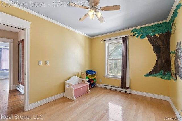 305 E 6th St, Monroe, MI 48161 - recreation room featuring a baseboard radiator, light wood-style flooring, ceiling fan, and crown molding