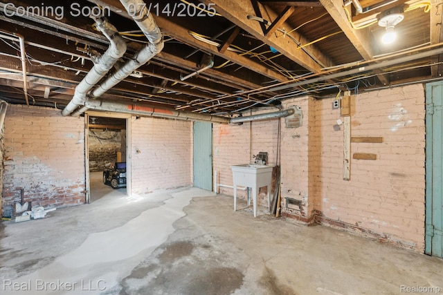305 E 6th St, Monroe, MI 48161 - unfinished basement featuring brick wall