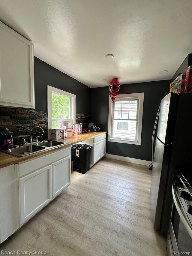 20245 Archdale St, Detroit, MI 48235 - kitchen featuring range with gas cooktop, healthy amount of natural light, light wood-style floors, and white cabinetry