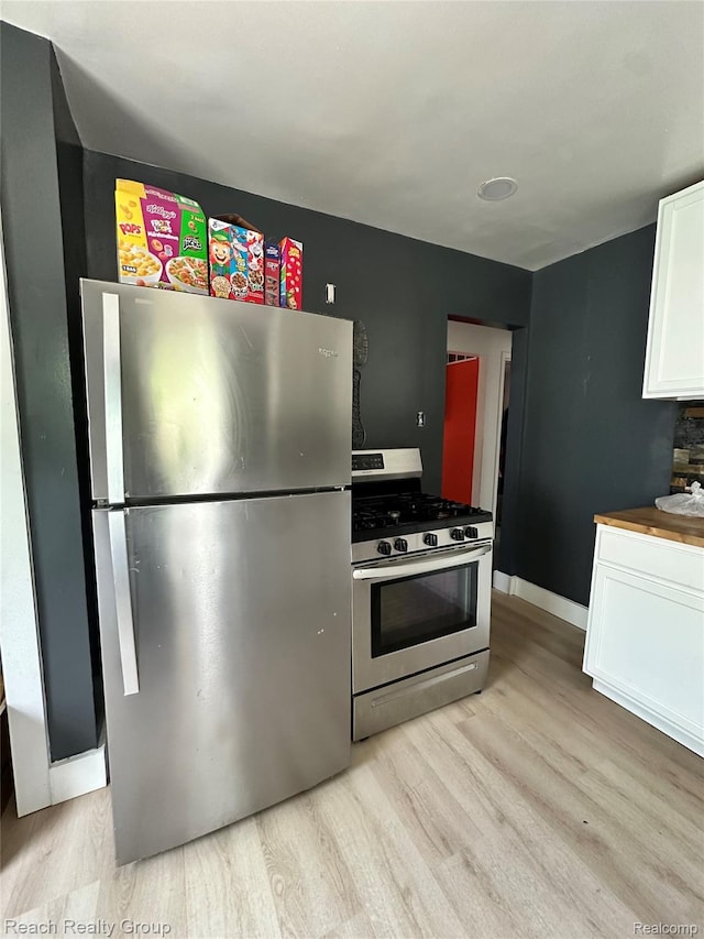 20245 Archdale St, Detroit, MI 48235 - kitchen featuring appliances with stainless steel finishes, light wood-type flooring, and white cabinetry