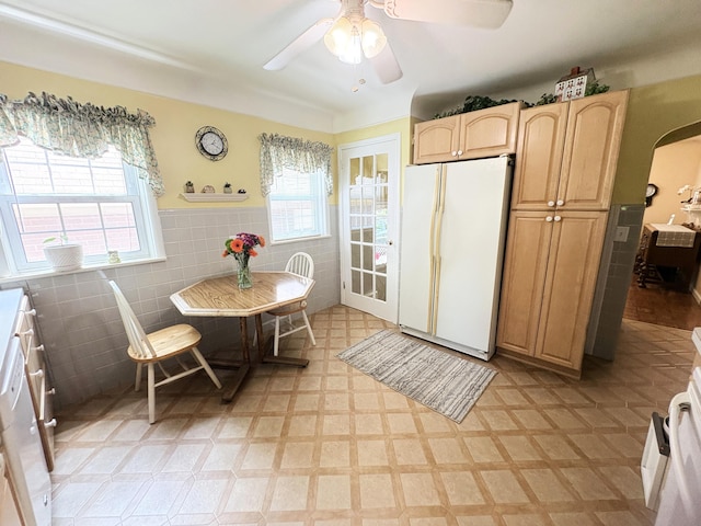19061 Collinson Ave, Eastpointe, MI 48021 - kitchen with freestanding refrigerator, tile walls, light flooring, arched walkways, and light brown cabinetry