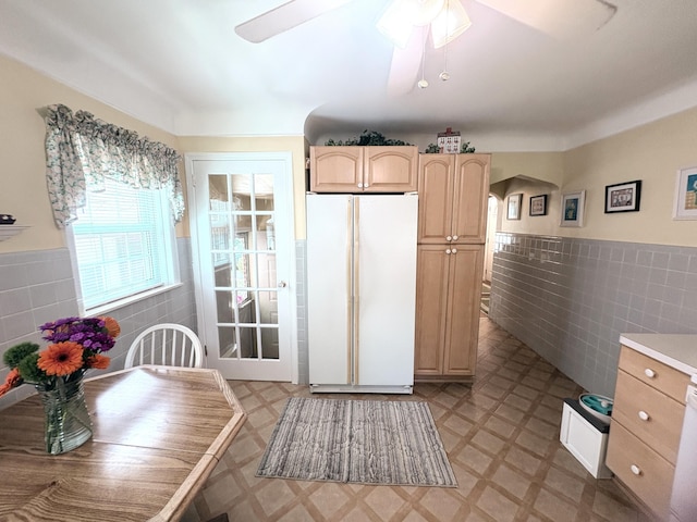 19061 Collinson Ave, Eastpointe, MI 48021 - kitchen with freestanding refrigerator, tile walls, light floors, wainscoting, and ceiling fan