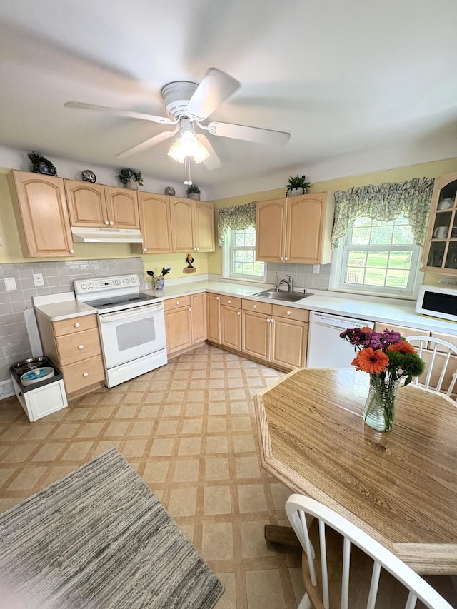 19061 Collinson Ave, Eastpointe, MI 48021 - kitchen featuring white appliances, light brown cabinetry, under cabinet range hood, and light countertops