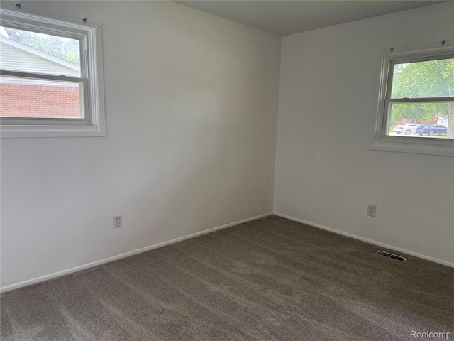 392 Hollywood Dr, Saline, MI 48176 - unfurnished room with dark colored carpet and baseboards