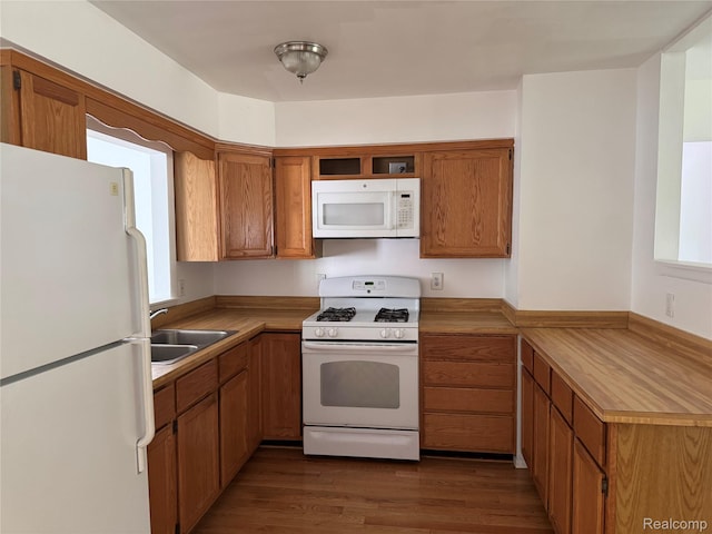 392 Hollywood Dr, Saline, MI 48176 - kitchen with white appliances, brown cabinetry, light countertops, dark wood-type flooring, and a peninsula