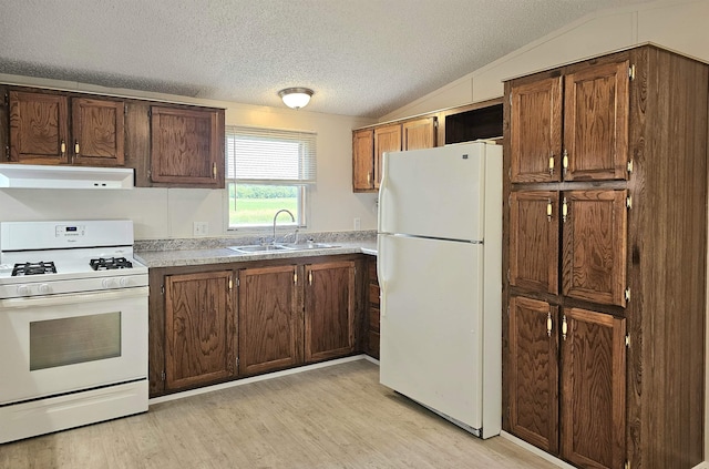 5955 N Pendell Rd, Elwell, MI 48832 - kitchen featuring white appliances, under cabinet range hood, light wood-style floors, vaulted ceiling, and light countertops