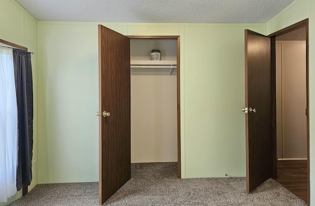 5955 N Pendell Rd, Elwell, MI 48832 - unfurnished bedroom with carpet flooring, a closet, and a textured ceiling