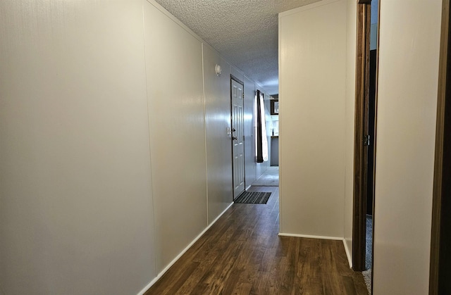 5955 N Pendell Rd, Elwell, MI 48832 - hallway featuring a textured ceiling and dark wood finished floors