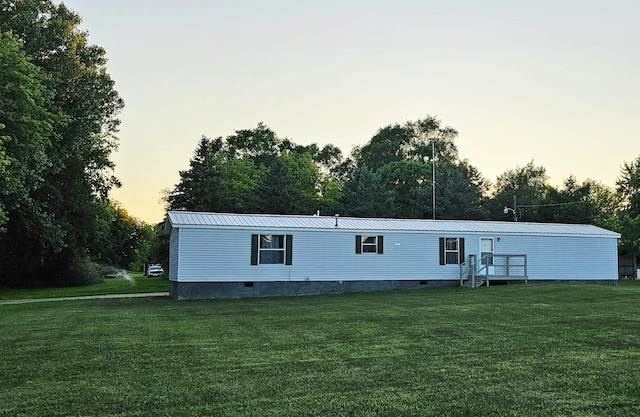 5955 N Pendell Rd, Elwell, MI 48832 - back of property featuring a lawn, a metal roof, and crawl space
