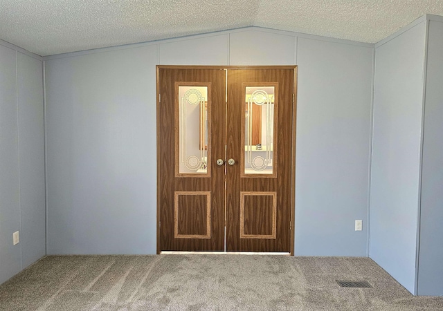 5955 N Pendell Rd, Elwell, MI 48832 - carpeted empty room with vaulted ceiling and a textured ceiling