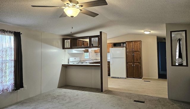 5955 N Pendell Rd, Elwell, MI 48832 - kitchen with white appliances, extractor fan, light carpet, ceiling fan, and a textured ceiling