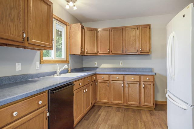 13280 Bradshaw St NE, Gowen, MI 49326 - kitchen with freestanding refrigerator, dishwashing machine, wood finished floors, and brown cabinets