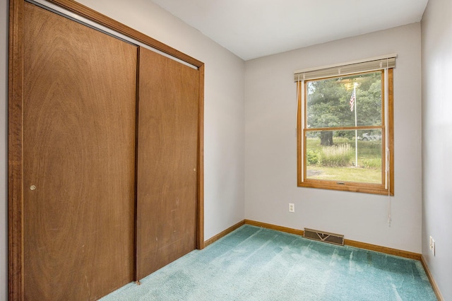 13280 Bradshaw St NE, Gowen, MI 49326 - unfurnished bedroom with a closet and carpet flooring