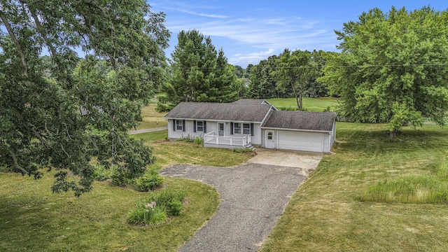 13280 Bradshaw St NE, Gowen, MI 49326 - view of front of home with a porch, a garage, asphalt driveway, and a front lawn