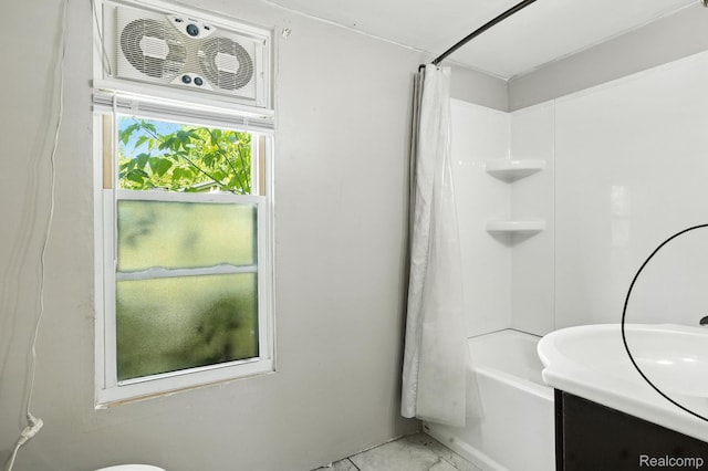 2424 10th Ave, Port Huron, MI 48060 - bathroom featuring vanity, shower / bath combo, and marble look tile flooring