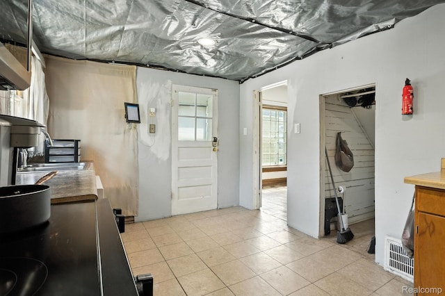 2424 10th Ave, Port Huron, MI 48060 - kitchen featuring light tile patterned floors and black / electric stove