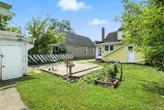 2424 10th Ave, Port Huron, MI 48060 - back of house with a patio, a chimney, a shingled roof, and an outdoor structure