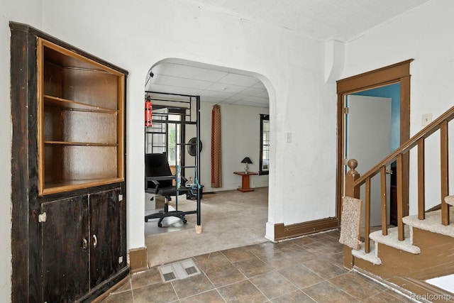 2424 10th Ave, Port Huron, MI 48060 - entryway with arched walkways, dark carpet, and stairs