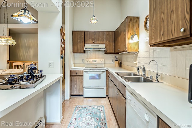 25104 Hamilton Ct Unit 4, South Lyon, MI 48178 - kitchen featuring white appliances, under cabinet range hood, light wood finished floors, backsplash, and light countertops