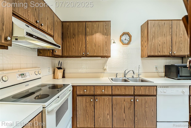25104 Hamilton Ct Unit 4, South Lyon, MI 48178 - kitchen featuring white appliances, under cabinet range hood, light countertops, and tasteful backsplash