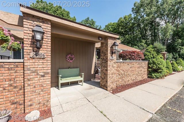 25104 Hamilton Ct Unit 4, South Lyon, MI 48178 - view of exterior entry featuring brick siding