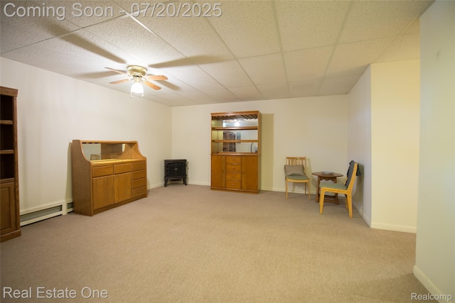25104 Hamilton Ct Unit 4, South Lyon, MI 48178 - sitting room with a baseboard radiator, light colored carpet, a ceiling fan, and a drop ceiling