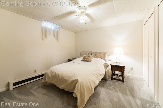 25104 Hamilton Ct Unit 4, South Lyon, MI 48178 - bedroom with a baseboard radiator, carpet floors, a paneled ceiling, a closet, and ceiling fan