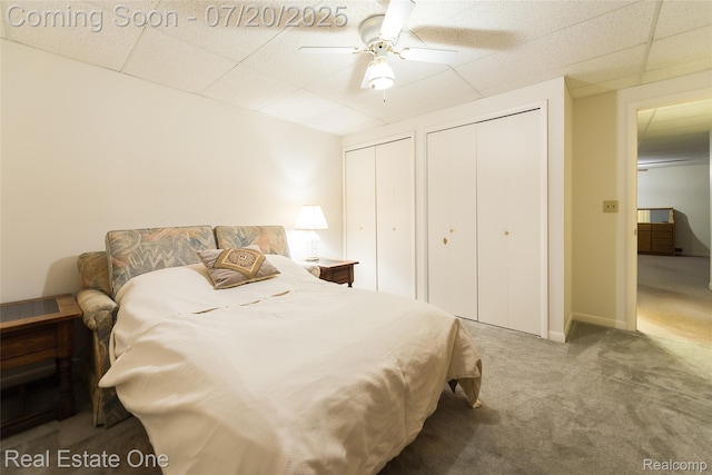 25104 Hamilton Ct Unit 4, South Lyon, MI 48178 - bedroom with two closets, carpet, a paneled ceiling, and a ceiling fan
