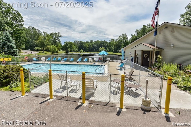 25104 Hamilton Ct Unit 4, South Lyon, MI 48178 - community pool with view of scattered trees