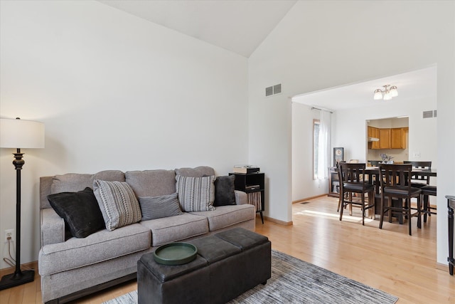 2388 Chestnut Cres, Saline, MI 48176 - living area with high vaulted ceiling and light wood-style flooring