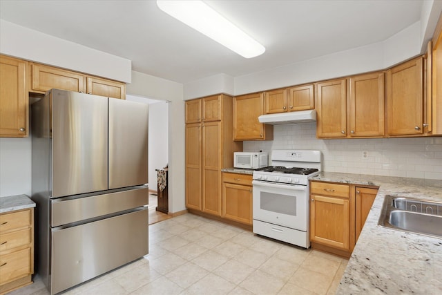 2388 Chestnut Cres, Saline, MI 48176 - kitchen with white appliances, under cabinet range hood, backsplash, and light stone counters