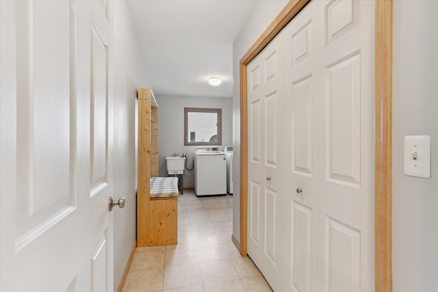 2388 Chestnut Cres, Saline, MI 48176 - hallway with washing machine and dryer and light tile patterned floors