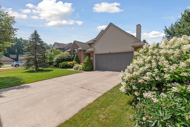 2388 Chestnut Cres, Saline, MI 48176 - view of front of home featuring brick siding, an attached garage, a front yard, and driveway