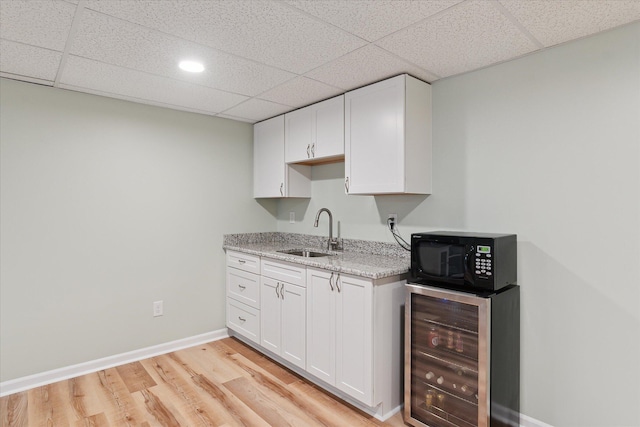 2388 Chestnut Cres, Saline, MI 48176 - bar area with beverage cooler, black microwave, a drop ceiling, light wood-style floors, and recessed lighting