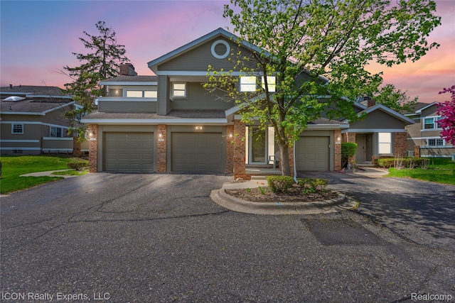 6614 Embers Ct, West Bloomfield, MI 48322 - traditional-style house with asphalt driveway, brick siding, and an attached garage
