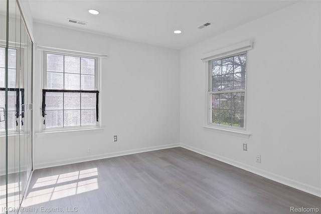 6614 Embers Ct, West Bloomfield, MI 48322 - empty room with wood finished floors and recessed lighting