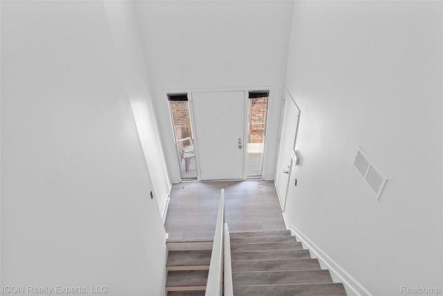 6614 Embers Ct, West Bloomfield, MI 48322 - staircase with wood finished floors and a high ceiling
