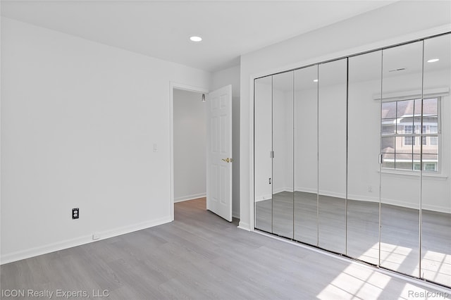 6614 Embers Ct, West Bloomfield, MI 48322 - unfurnished bedroom featuring wood finished floors, recessed lighting, and a closet