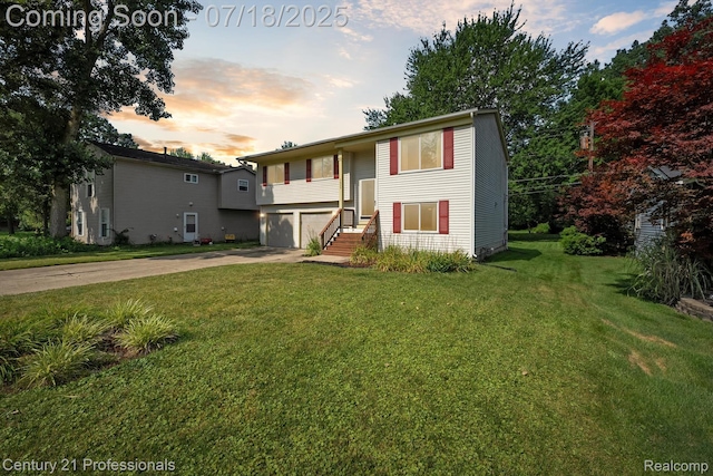 1605 N Hanlon St, Westland, MI 48185 - split foyer home featuring driveway, an attached garage, and a front yard