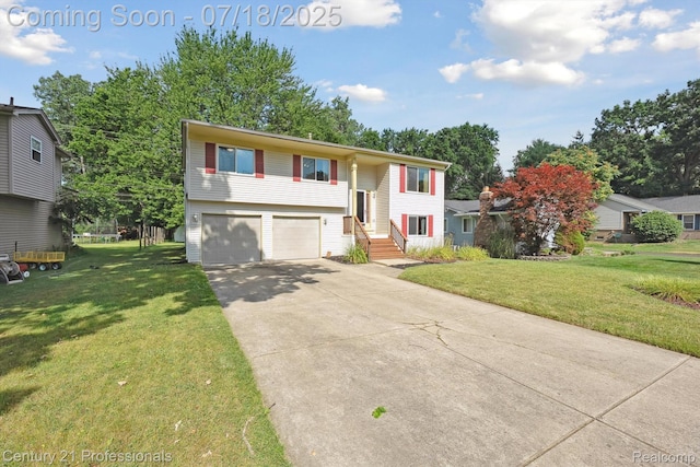 1605 N Hanlon St, Westland, MI 48185 - split foyer home with concrete driveway, an attached garage, and a front yard