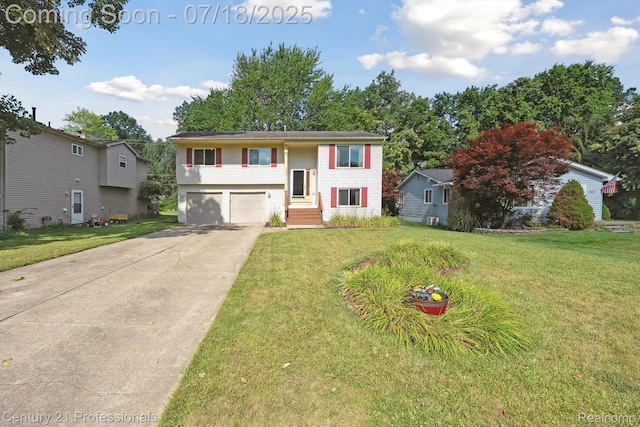 1605 N Hanlon St, Westland, MI 48185 - raised ranch featuring a garage, driveway, and a front yard