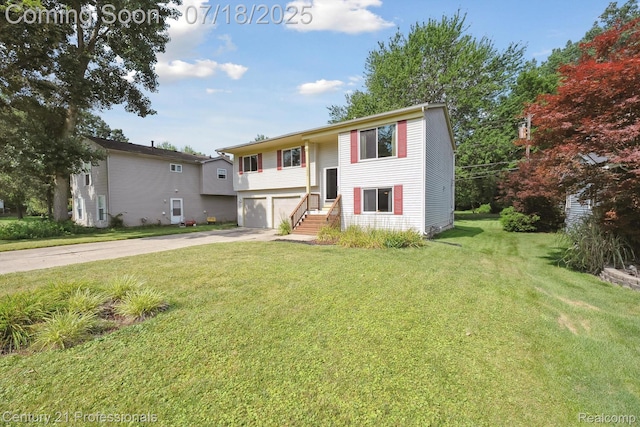 1605 N Hanlon St, Westland, MI 48185 - split foyer home featuring concrete driveway, a garage, and a front lawn