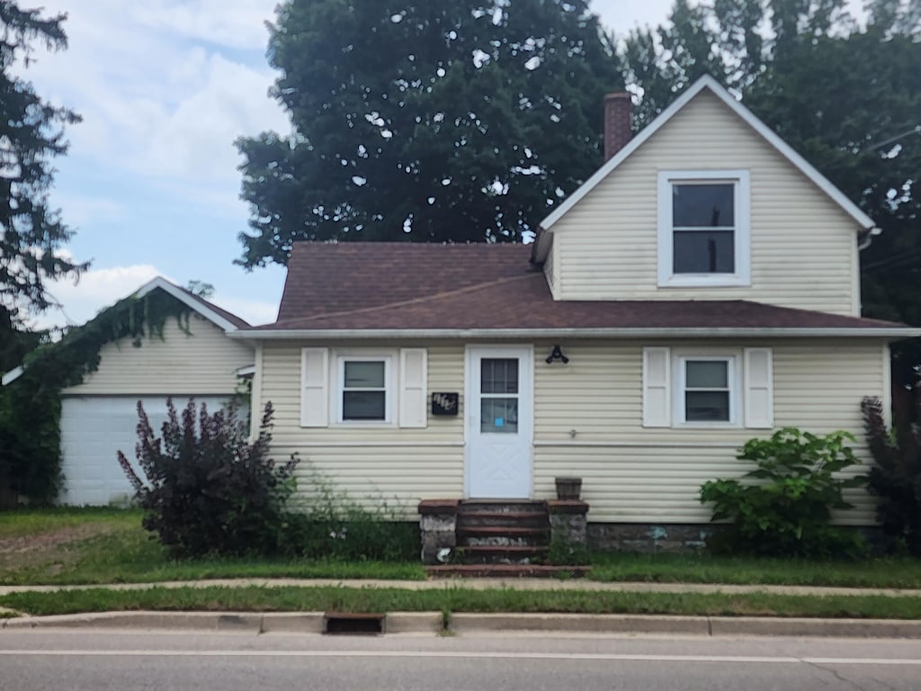 1114 Lake St, Niles, MI 49120 - view of front of home featuring entry steps, an attached garage, and a chimney