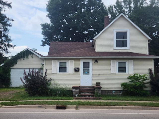 1114 Lake St, Niles, MI 49120 - view of front of home featuring entry steps, an attached garage, and a chimney