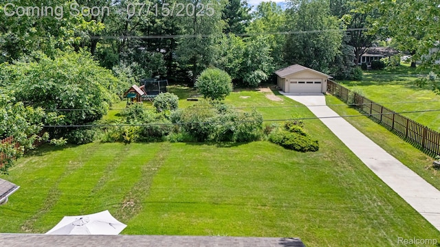 3290 Welch, Commerce Twp, MI 48390 - view of yard featuring concrete driveway, an outbuilding, and an attached garage