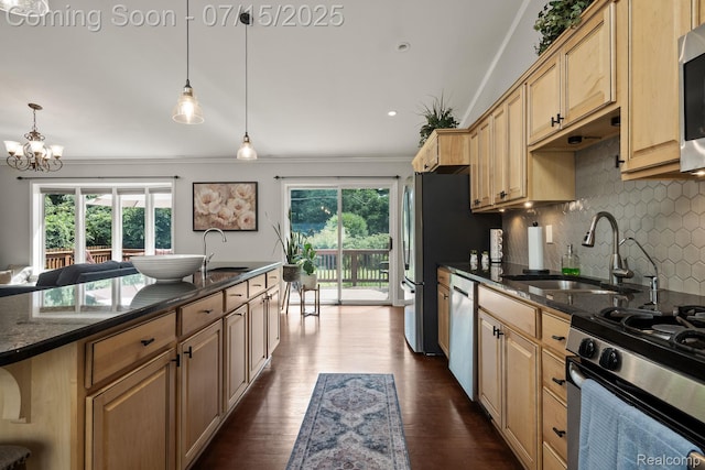 3290 Welch, Commerce Twp, MI 48390 - kitchen featuring decorative backsplash, appliances with stainless steel finishes, a chandelier, ornamental molding, and dark stone counters