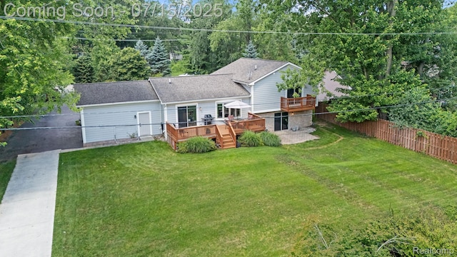 3290 Welch, Commerce Twp, MI 48390 - back of house with a wooden deck and driveway