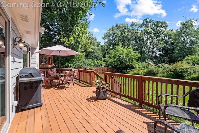 3290 Welch, Commerce Twp, MI 48390 - deck featuring area for grilling, view of wooded area, and outdoor dining space