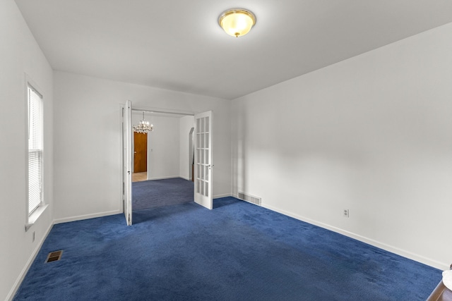 622 Tromley St, Inkster, MI 48141 - unfurnished room featuring a chandelier, dark colored carpet, and french doors