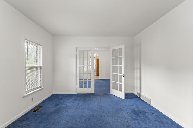 622 Tromley St, Inkster, MI 48141 - unfurnished room with french doors, dark colored carpet, and a chandelier